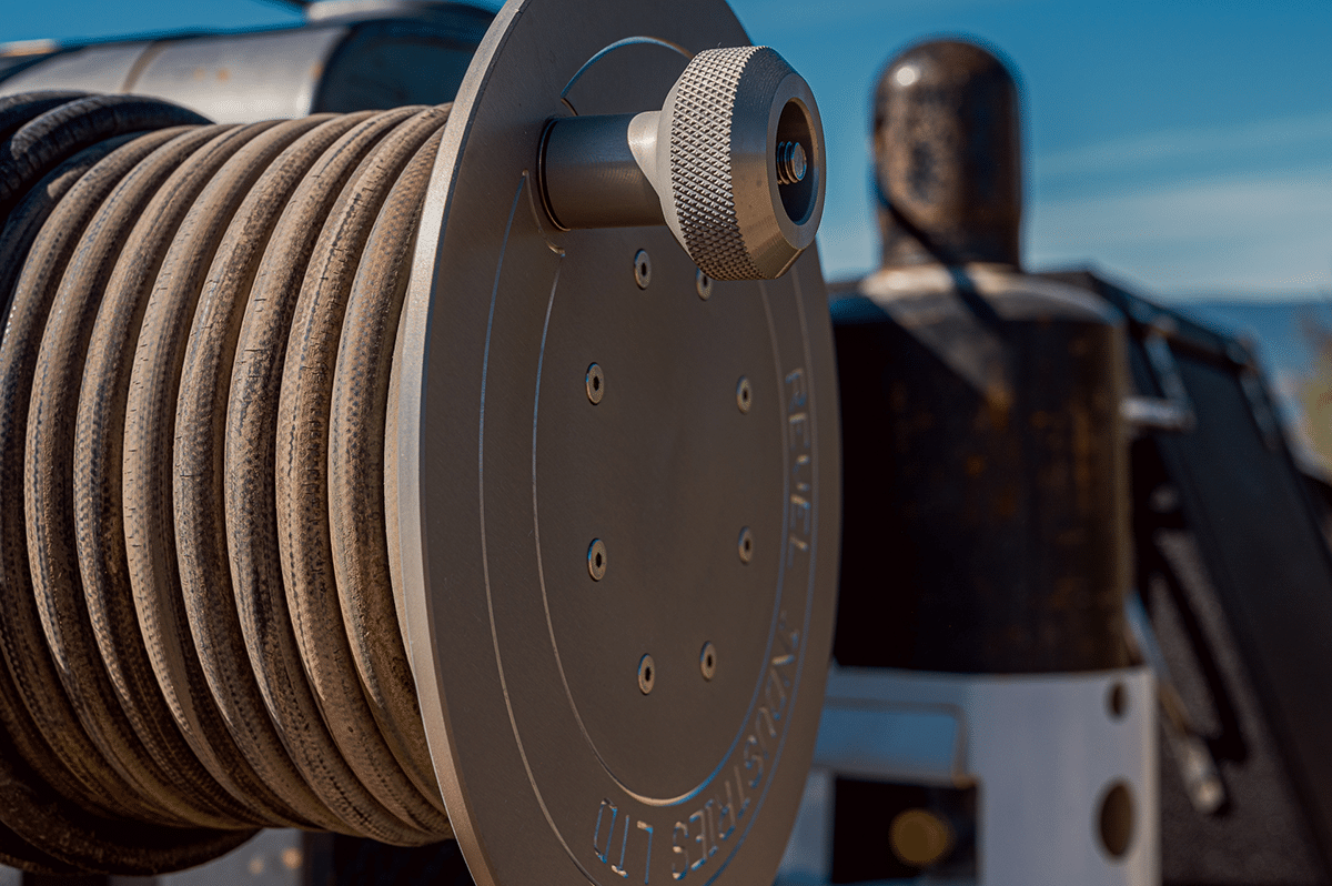 A close-up view of a fire truck hose, showcasing its texture and connection to the vehicle