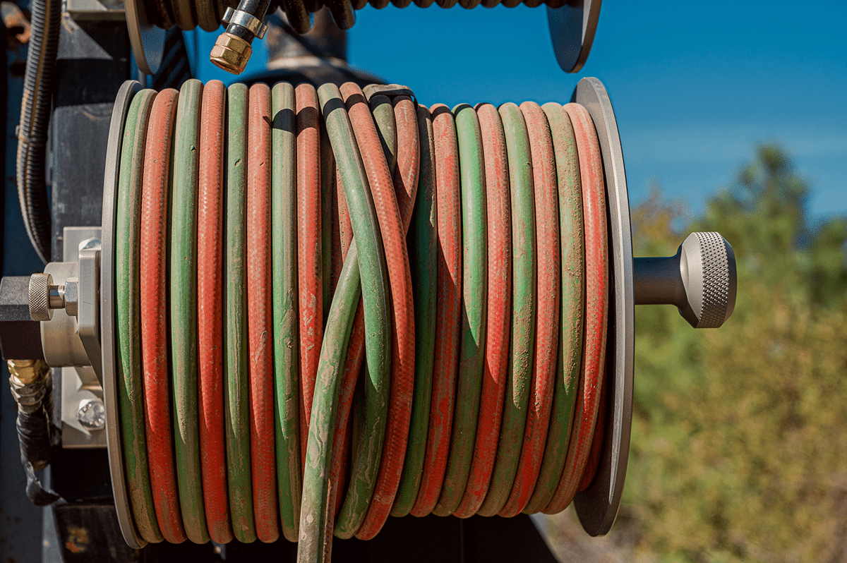 A close-up view of a hose surrounded by various colored hoses, showcasing a vibrant array of hues and textures
