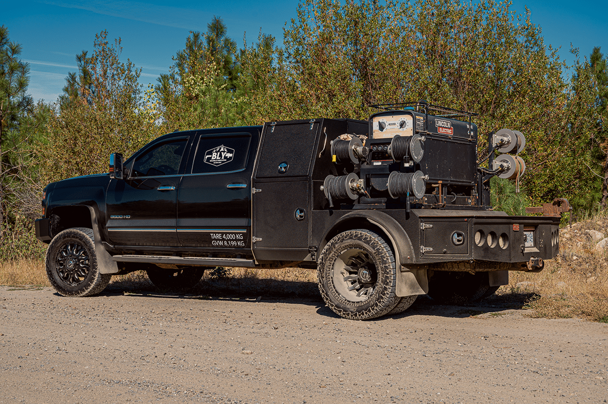 A truck equipped with a large air compressor, showcasing Revel Industries' innovative product reel