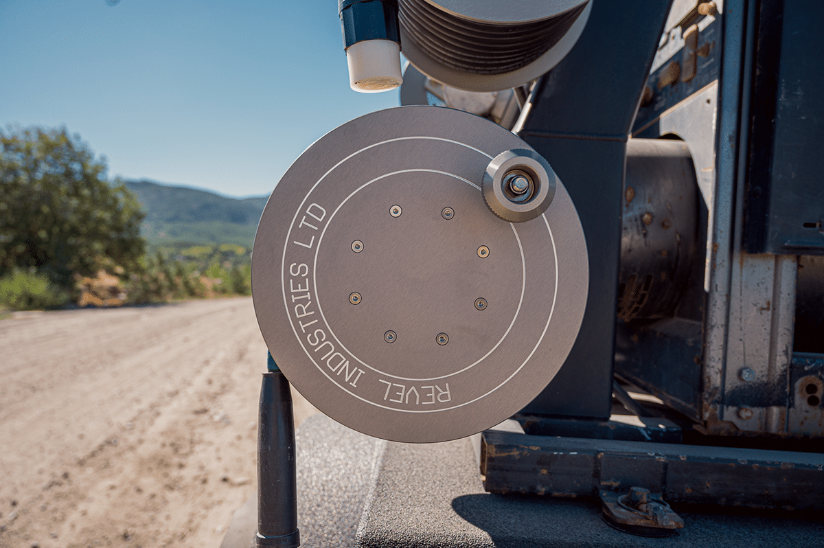 A close-up of a truck tire, showcasing the Revel Industries product reel securely mounted on the vehicle