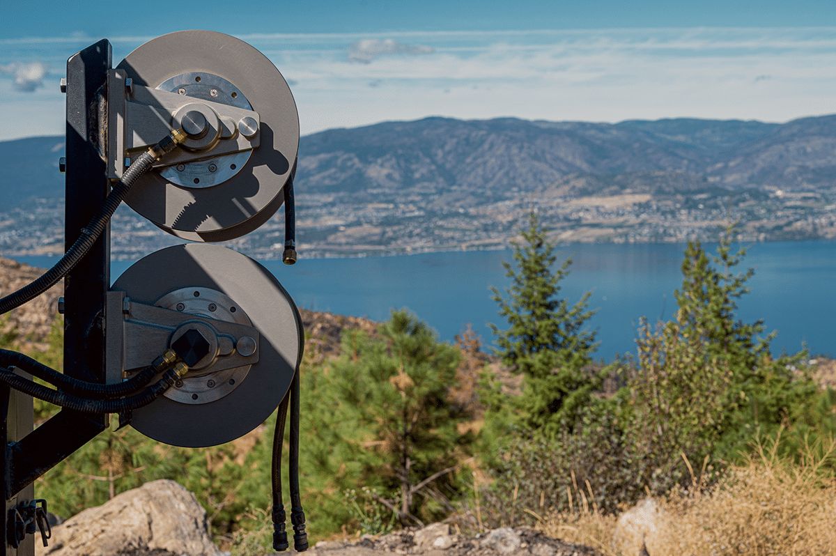 A breathtaking mountaintop view showcasing mountains and a serene lake, framed by scenic reels in the background