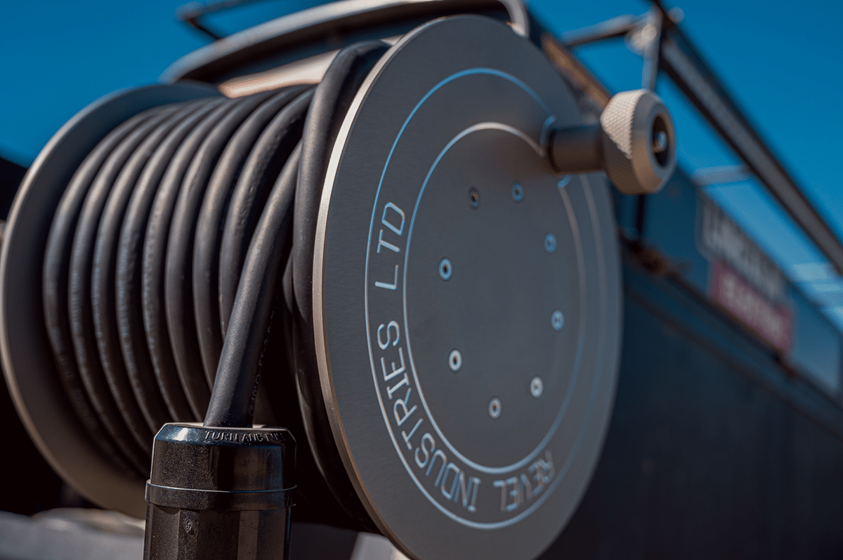A close-up view of a hose reel mounted on a truck, showcasing its design and functionality