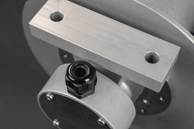 A close-up of a metal machine featuring a bolt and nut, highlighting a 30amp reel component