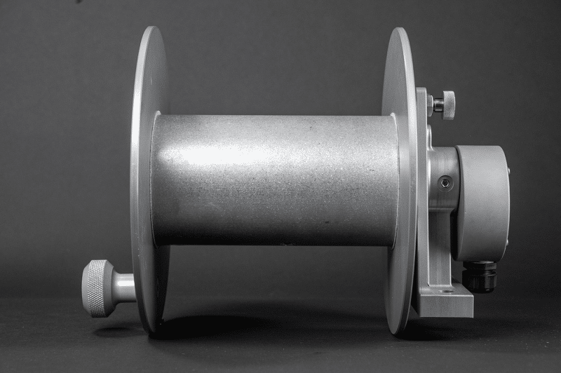 A 30amp reel with a metal cover displayed against a black background