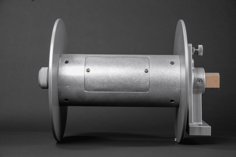A reel featuring both a metal and a wooden handle, designed for air use, showcasing its dual-handle functionality
