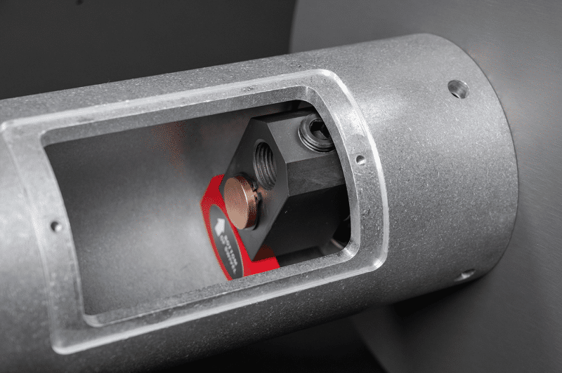 A close-up view of a metal air reel machine featuring a prominent red button