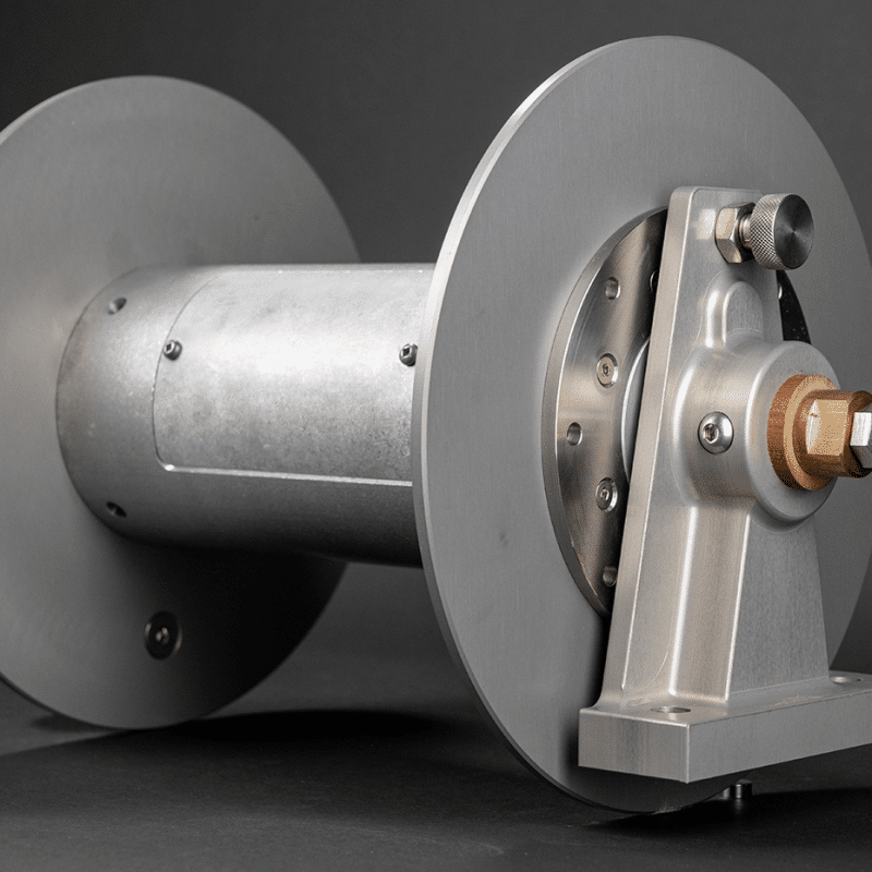 A metal cable reel featuring a strong shaft and protective cover, designed for efficient cable storage and management