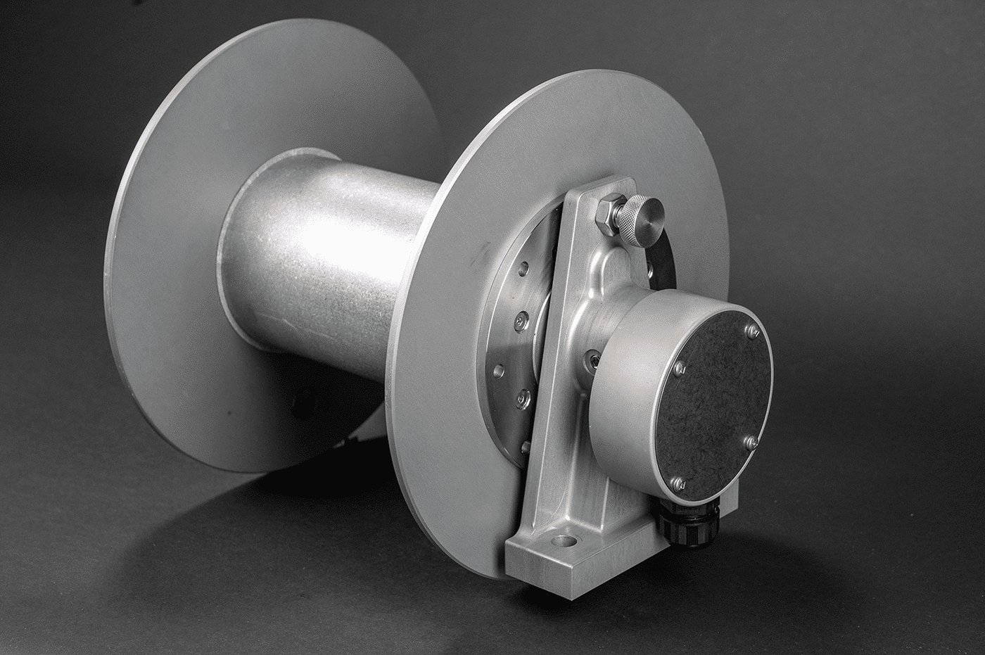 A 30amp reel with a metal cover displayed against a black background, featuring Cable Reels